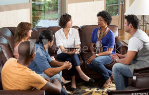 Group of 6 people sitting on a couch having a peer counseling session